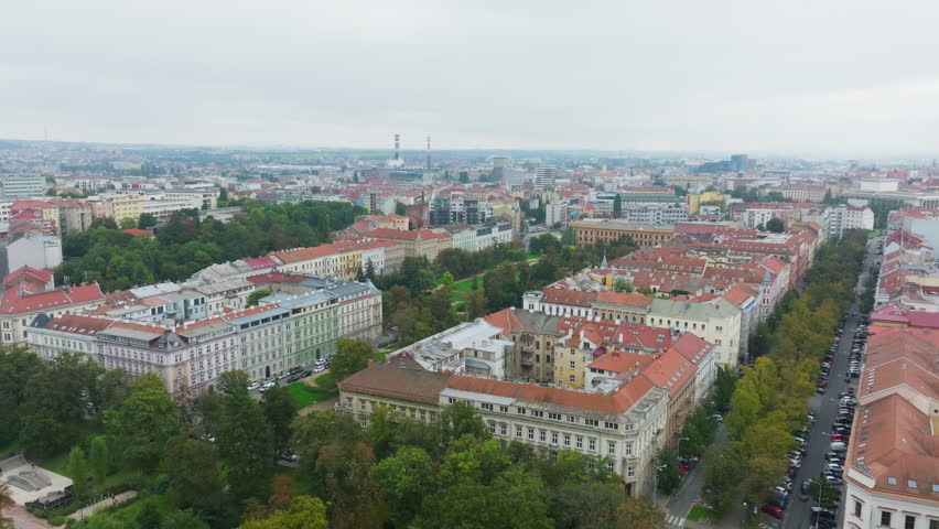 Camera moving over historical buildings in the city of Brno, Czech Republic, showing urban layout, parks and gardens