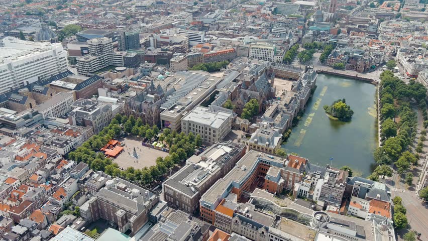 Dolly zoom. The Hague, Netherlands. Binnenhof. Hofvijver lake in the historical city center. Cloudy weather. Summer day, Aerial View, Departure of the camera