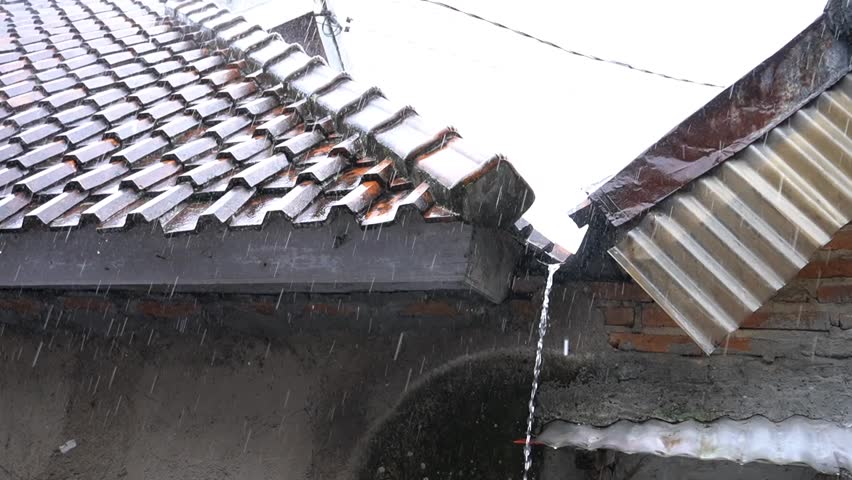 TASIKMALAYA, INDONESIA - November 2, 2024 - Heavy rainstorms made water flow from the roof tiles of the house