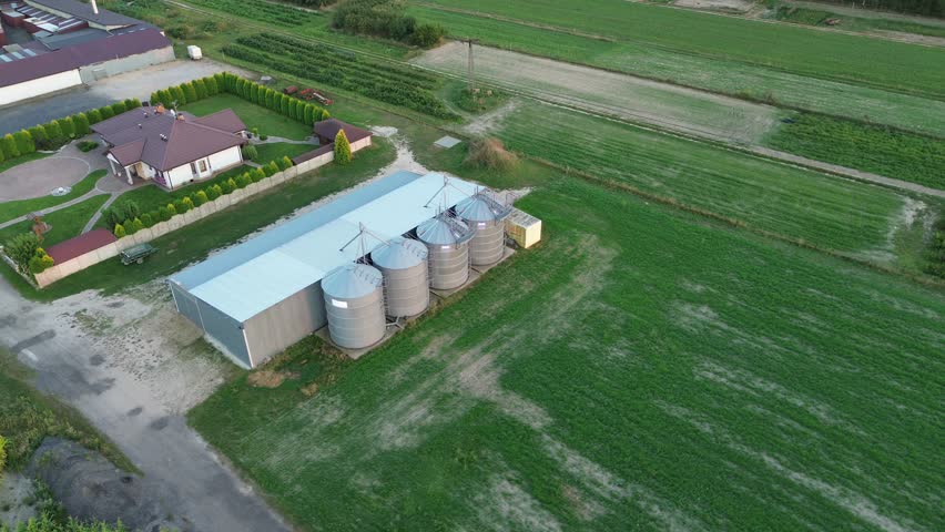 Rural landscape with house and grain silos
