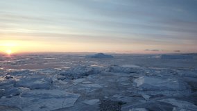 A mesmerizing aerial shot captures the uneven layers of icebergs and fragmented sea ice drifting together in the chilly waters of Greenland - Powered by Shutterstock - Get 15% off with code: PIKWIZARD15