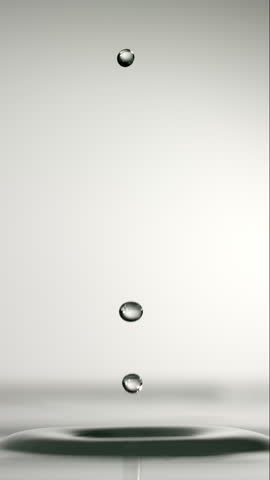 Captivating slow-motion footage shows a water drop hitting the surface, creating mesmerizing concentric ripples that elegantly expand outward