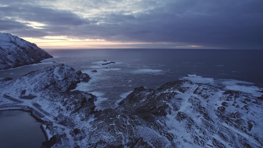 Rocky coast in the far north, Norwegian Sea. Late sunset.
