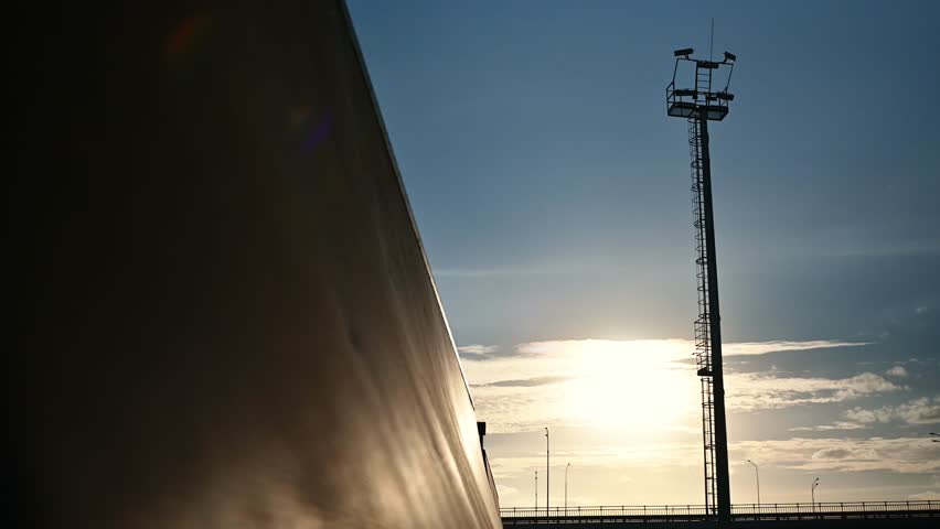 The athlete actively spends time at sunset. A cyclist rides on trampolines . A stuntman performs stunts on a bmx bike