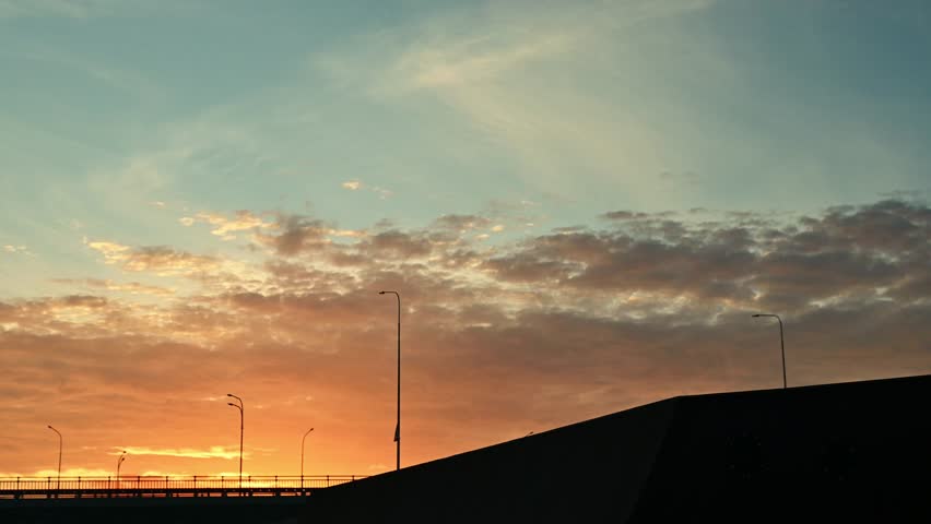 The athlete actively spends time at sunset. A cyclist rides on trampolines . A stuntman performs stunts on a bmx bike