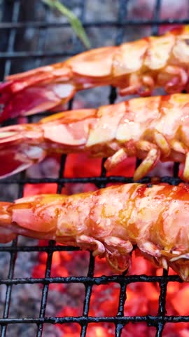 grill shrimp , barbecue sea food on fire flaming slow motion