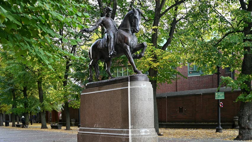 Boston, MA, USA - October 1, 2024: the iconic architecture of Boston showcasing the famous Paul Revere Riding a Horse statue at Hanover street across the Old North Church on a sunny day.