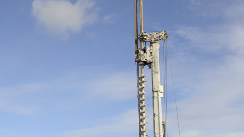 Building activity on contruction site.Drilling machine.Wind turbine construction. Excavator and other construction equipment.