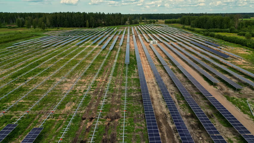 Photovoltaic Panels Mounted On Field. Solar Power Plant. drone shot