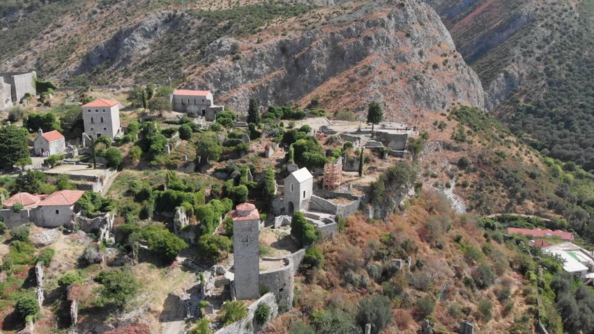 Aerial: Stari Bar or Bar old town in Montenegro. Drone flying over the town by the cliff