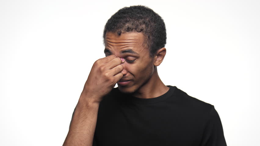 Man Pinching Nose Symbolizing Headache on White Background