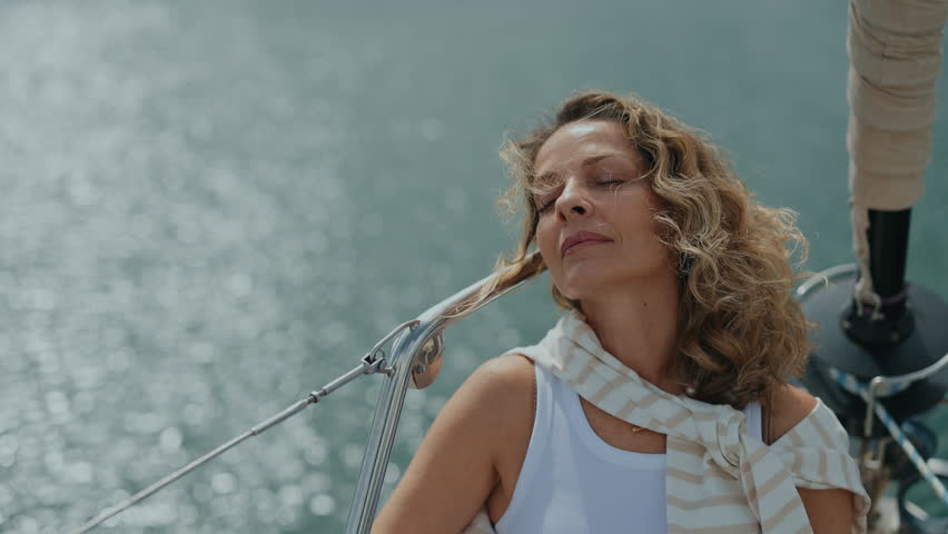 Portrait Of Beautiful Woman. She Is Enjoying Sunny Day On Yacht.
