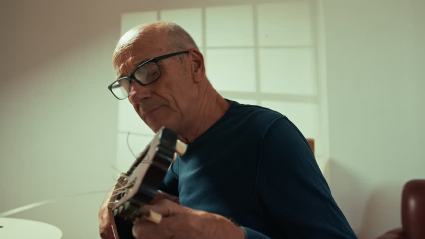 Old Man Learing Guitar Tuning On Online Lesson 