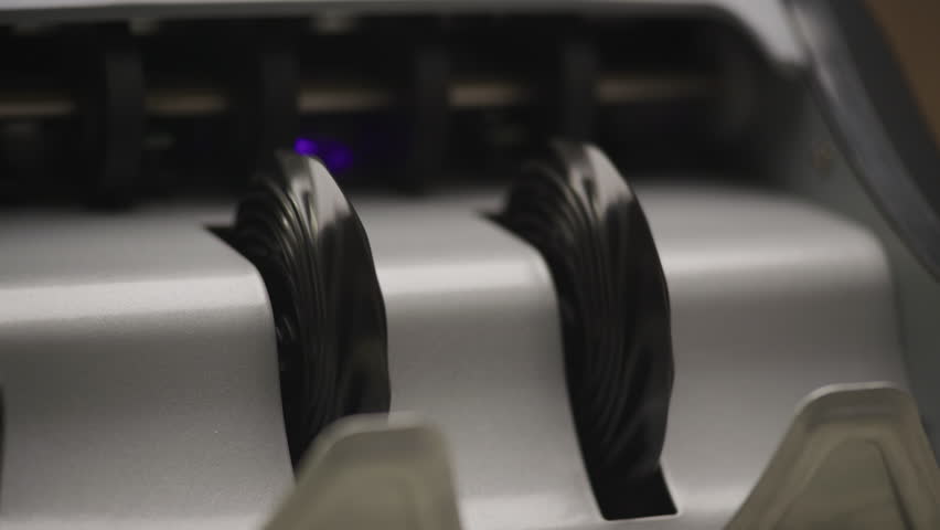 Close-Up of 100 Dollar Bills Moving Through Money Counter