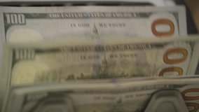 Close-Up of 100 Dollar Bills Moving Through Money Counter - Powered by Shutterstock - Get 15% off with code: PIKWIZARD15