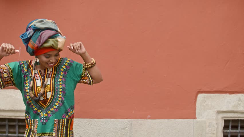 Cute African American woman dancing in funny way. Moving from side to side of screen. Actively jumping and swinging her hands. Positive woman. Person smiling widely and showing positivity.