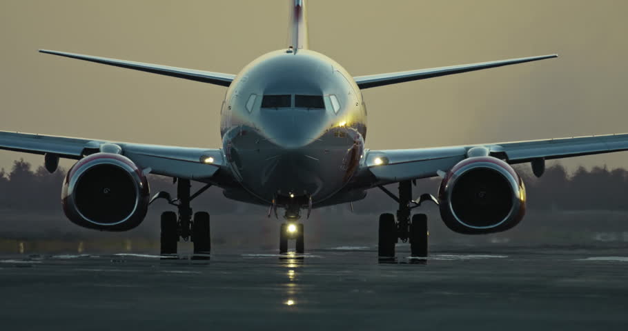 Passenger Airplane Taxiing on Runway After Landing at Sunset Showcasing Airport Life and Aviation Travel. High quality 4k footage