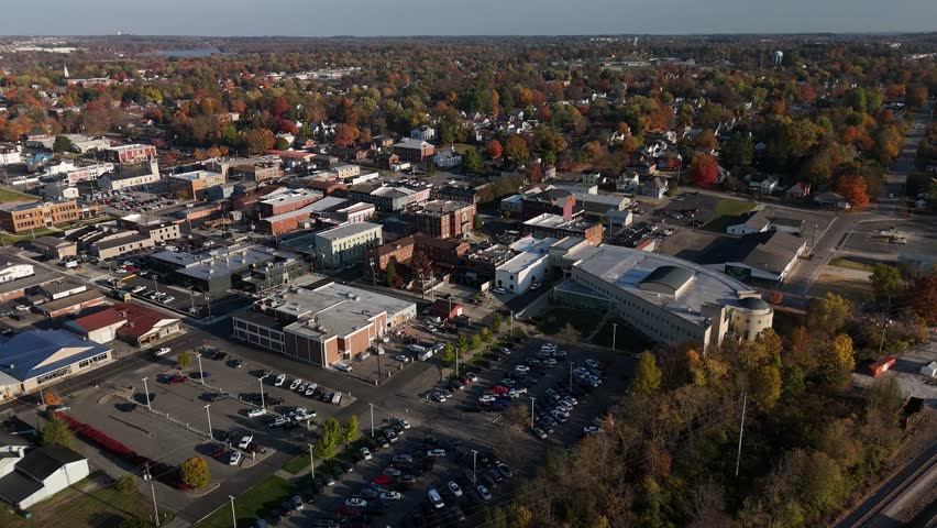 Drone approaching old courthouse building in Elizabethtown, Kentucky with roundabout traffic around it.