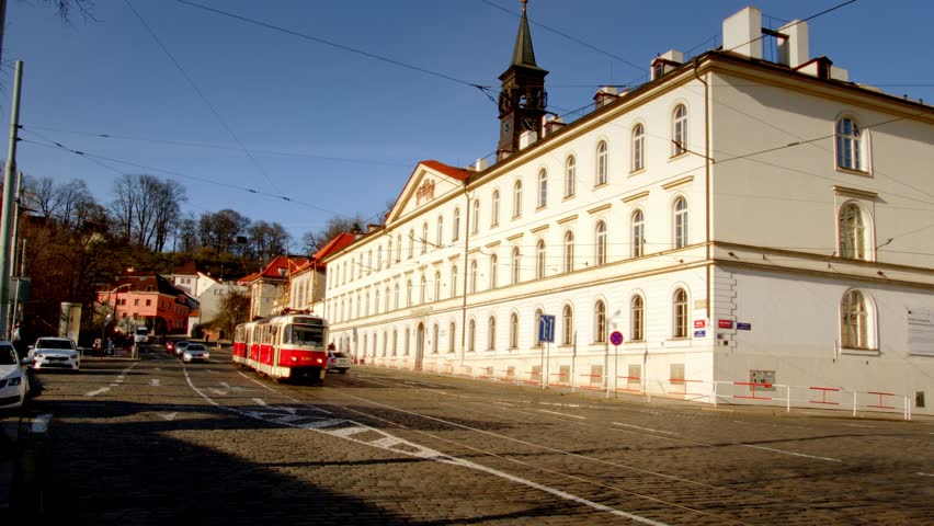 Stunning view of historic European architecture with a tram passing through in Prague, Czech Republic.