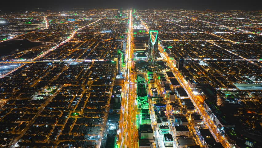 Drone hyperlapse of Riyadh cityscape showing the Kingdom Tower on King Fahad Road and KAFD in the background at night, Saudi Arabia