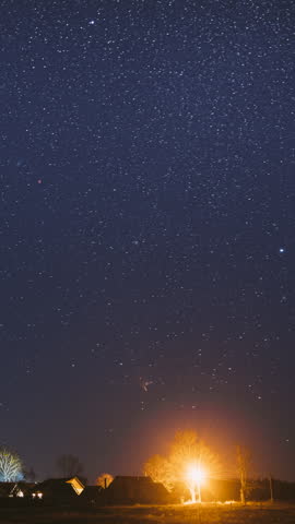 Real Night Sky Stars Above Old Village. Natural Starry Sky Above Rural Countryside Landscape In Belarus.