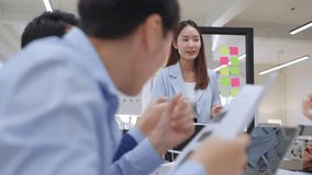 Modern office with an Asian business team sharing creative ideas. Collaborative professionals brainstorming strategies in a sleek, innovative environment, promoting teamwork and diversity - Powered by Shutterstock - Get 15% off with code: PIKWIZARD15