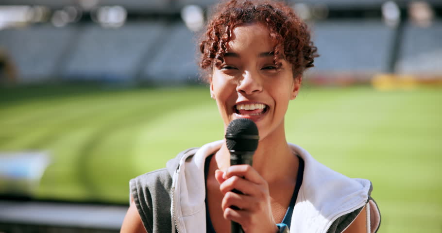 Athlete, microphone and laugh in stadium for interview, press conference and sports with broadcast. Woman, speaking and media relations presentation in arena for fitness event, television and news
