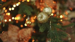 Merry Christmas Xmas happy holidays. Golden ornament decoration ball and defocused garland lights on classic decorated Christmas tree. Christmas tree with gold ornaments. Christmas eve at home - Powered by Shutterstock - Get 15% off with code: PIKWIZARD15