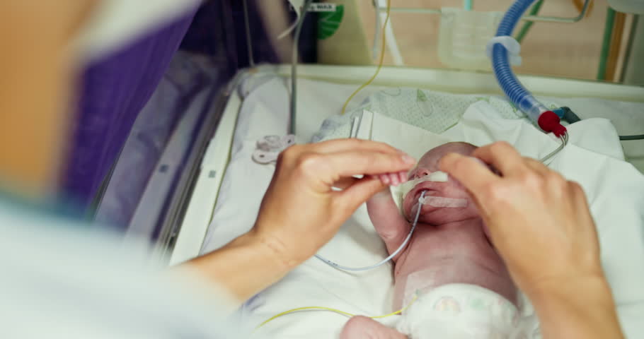 A healthcare professional is providing care for a premature infant in a neonatal intensive care unit. A Tender Moment Shared Between a Loving Parent and Their Newborn Baby in the NICU