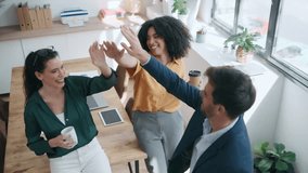 Video of business team celebrating good job while holding up their right hands on modern startup - Powered by Shutterstock - Get 15% off with code: PIKWIZARD15