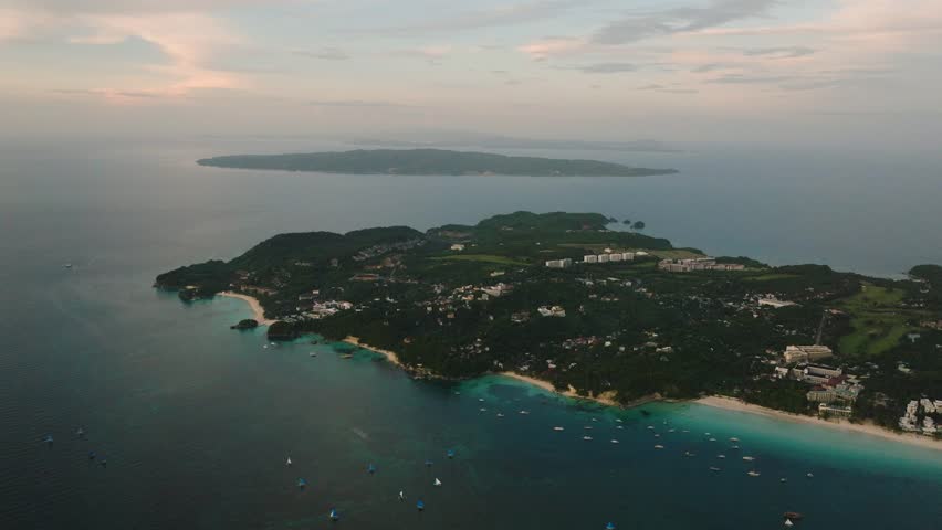 Tropical turquoise sea water with tourboats. White sand beaches in Boracay, Philippines.