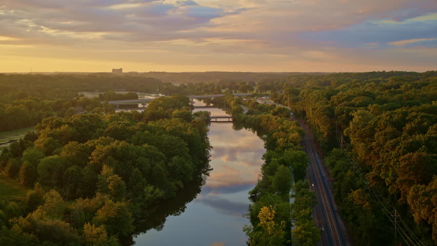 Aerial footage of a slow-moving drone over the Huron River in Ann Arbor, Michigan, during the summer season.