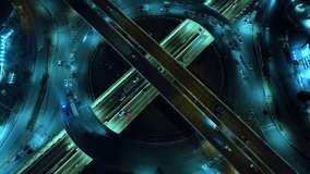 Time-lapse of car traffic transportation on road at junction intersection, 4K. Aerial view of road interchange or highway intersection with busy urban traffic speeding on the road at night. expressway - Powered by Shutterstock - Get 15% off with code: PIKWIZARD15