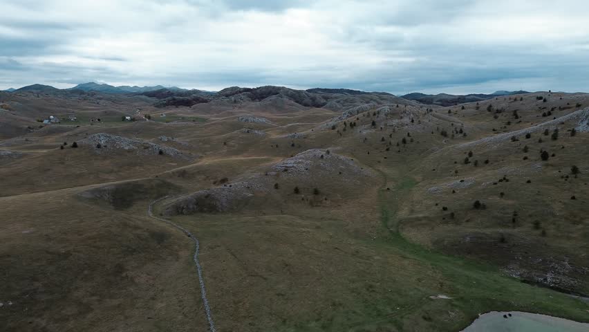Riblje jezero - Fish Lake- a glacial reservoir in Durmitor National Park, Montenegro country. Panoramic aerial top view from drone. Calm autumn landscape scene