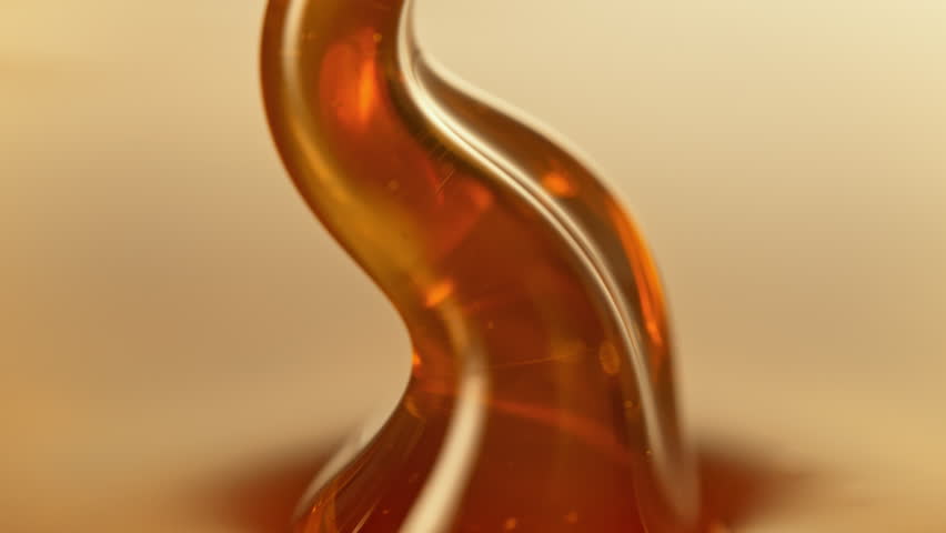 Super Slow Motion Detail Shot of Pouring and Layering Premium Honey at 1000fps.