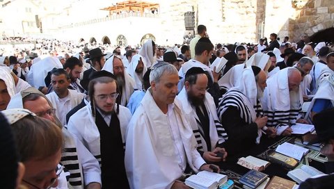 JERUSALEM, ISRAEL -  MARCH 28: Thousands of Jews practice the Priestly Blessing  (Hebrew - Birkat Cohanim) at the Western Wall plaza during the Passover Holiday, March 28 2013 in Jerusalem, Israel.