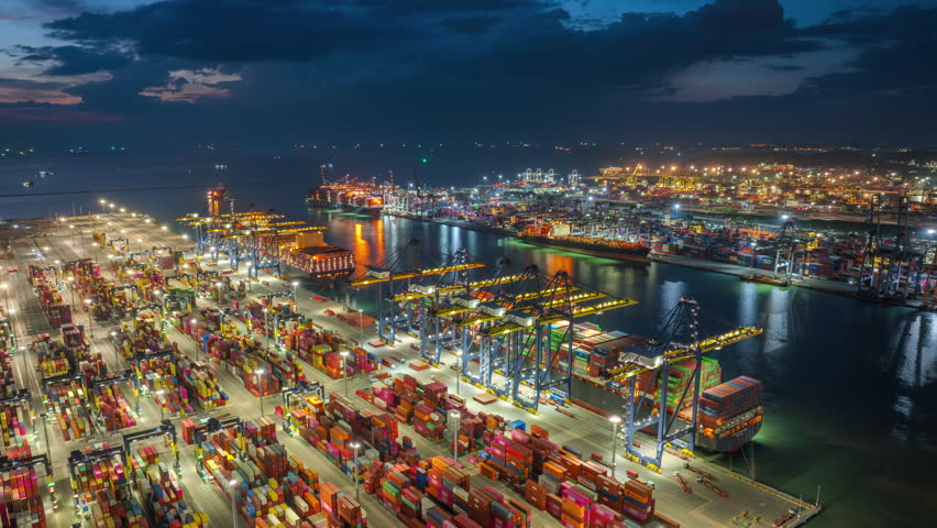 Large cargo ships parked at a large export warehouse in an industrial area. Future transportation innovation on a global network. Container distribution network, shipping, online ordering worldwide.