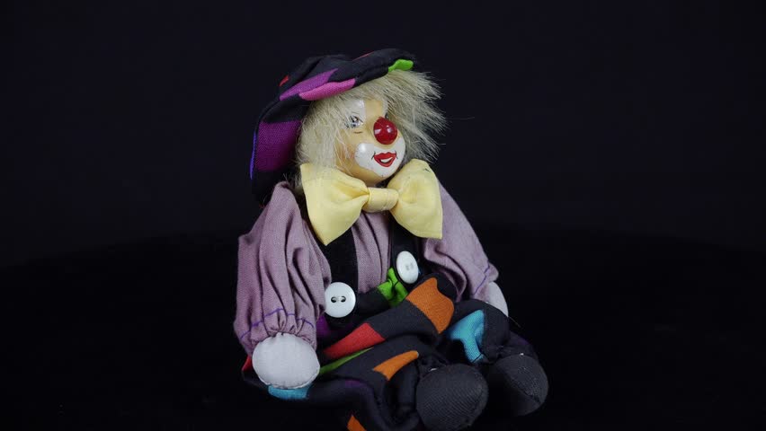 Berdichev, Ukraine - November 9, 2024.Vintage Circus Smiling Clown Toy On Black Background.