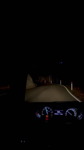 driving down a mountain road at night