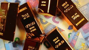 Shiny Gold Bars on the 20 Euro Bills - Top View. Euro Money Currency. A Lot of Twenty Euro Banknotes. Success, Finances and Wealth Concept - Rotation Left - Powered by Shutterstock - Get 15% off with code: PIKWIZARD15