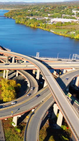 Aerial view of twisting highway in downtown Albany New York. Automobile overpasses on the banks of the Hudson River. Vertical video.