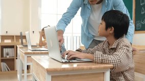 Caucasian teacher helping asian student coding engineering prompt while diverse student using software generated AI. Smart happy attractive children sitting and programing system. Education. Pedagogy. - Powered by Shutterstock - Get 15% off with code: PIKWIZARD15