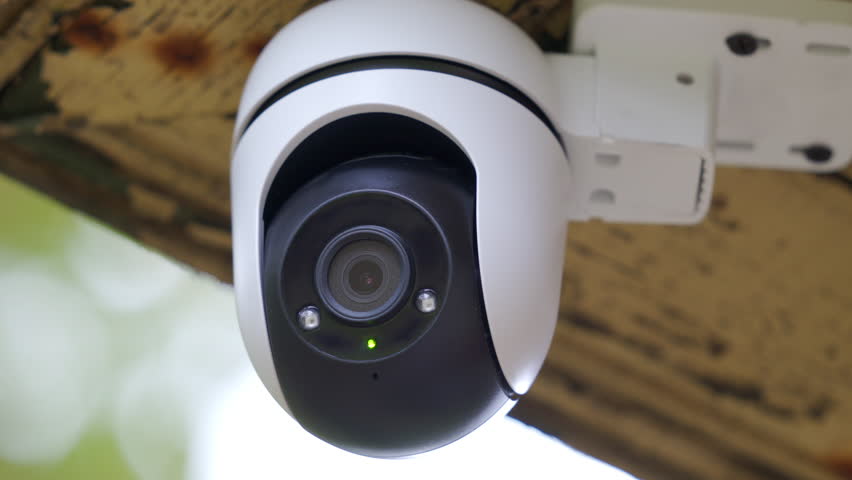 Security outdoor PTZ surveillance camera installed under the roof of the house. Pan tilt zoom camera provide HD view zoom and 360 rotation for full security coverage.