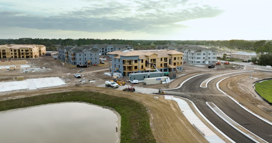 Wooden apartment buildings under construction in new developing suburban area. Development of residential housing in Florida suburbs. Real estate market in the USA.