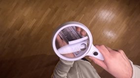 pov First person view Person inspecting one hundred dollar bill magnifying glass - Powered by Shutterstock - Get 15% off with code: PIKWIZARD15