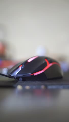 gaming mouse lights up in different colors on black table	