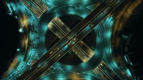 Time-lapse of car traffic transportation on road at junction intersection, 4K. Aerial view of road interchange or highway intersection with busy urban traffic speeding on the road at night. expressway - Powered by Shutterstock - Get 15% off with code: PIKWIZARD15