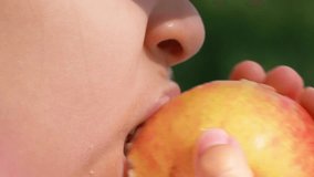 Close up of a little girl eating an apple with nature in the background - Powered by Shutterstock - Get 15% off with code: PIKWIZARD15