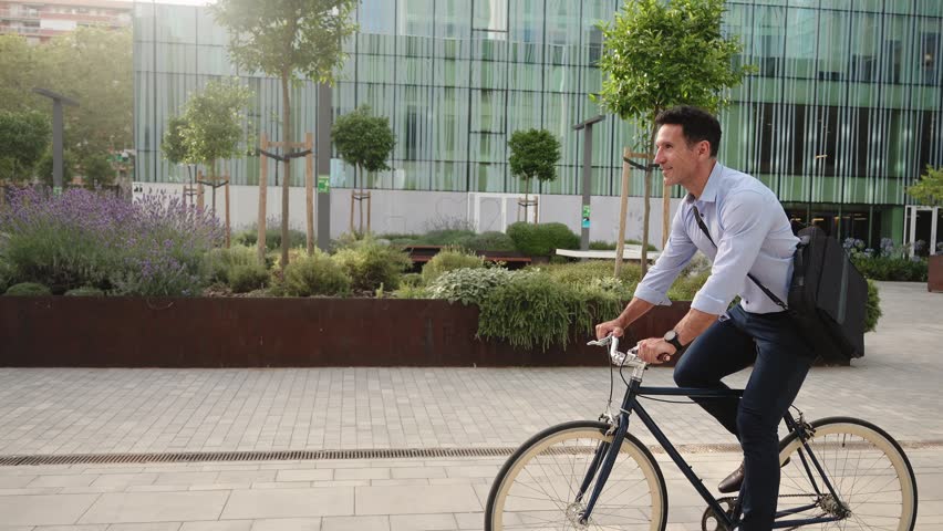 Businessman commuting to work by bicycle in the morning