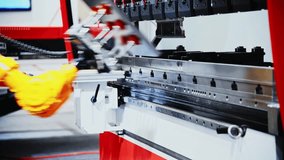 Pick and place industrial robotic arm manipulator moving sheet metal: part of hydraulic press bending machine - Powered by Shutterstock - Get 15% off with code: PIKWIZARD15